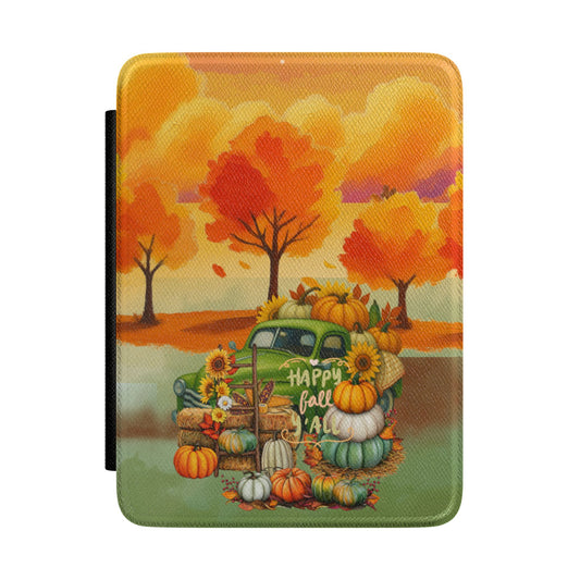 A tablet case featuring a colorful autumn landscape illustration with orange trees, a green pickup truck loaded with pumpkins and sunflowers, and the words 'Happy Fall All,' shown on a plain white background.