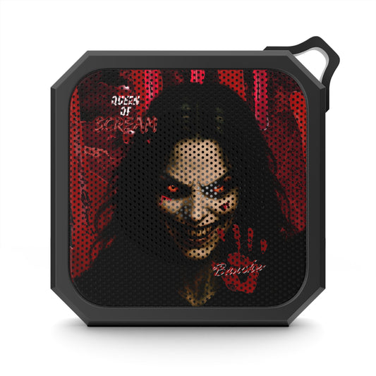 A portable speaker with a black frame and a graphic print of a creepy clown face with glowing red eyes, red handprints, and the text 'ACCES TO SCREAM' and 'Bitches' on a white background.