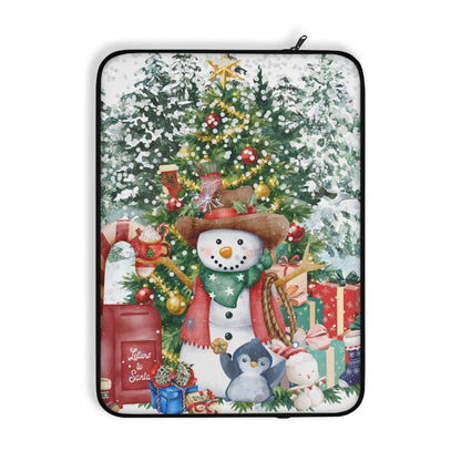 A laptop sleeve featuring a festive Christmas illustration with snowmen, a decorated tree, snow, and wrapped gifts, shown on a plain white background.