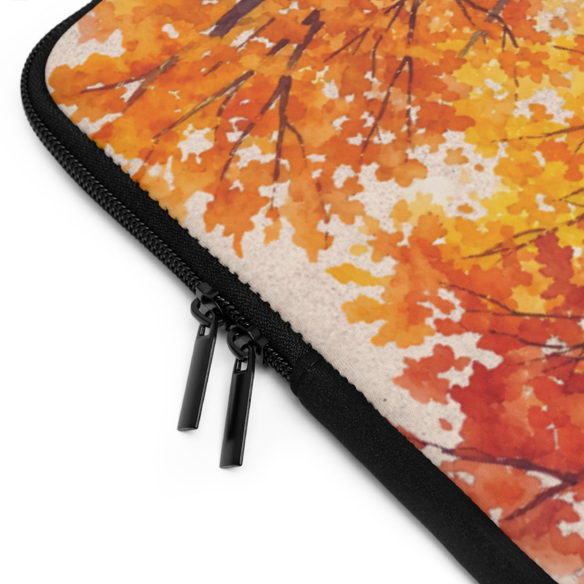 Close-up of a zippered sleeve or case with a watercolor autumn leaf pattern in orange, yellow, and red on a white background.