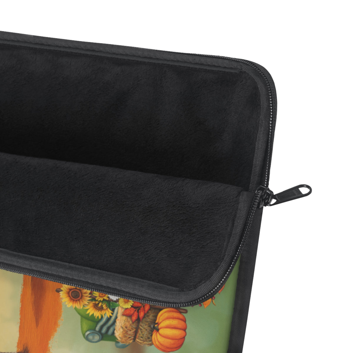Close-up of an open zippered pouch showing a black fleece interior lining and a printed exterior design with sunflowers, pumpkins, and a green background.