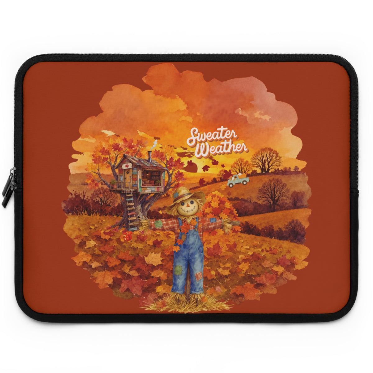 A laptop sleeve featuring an autumn-themed illustration with a scarecrow, treehouse, fall leaves, and the words 'Sweater Weather' on a rust-orange background.