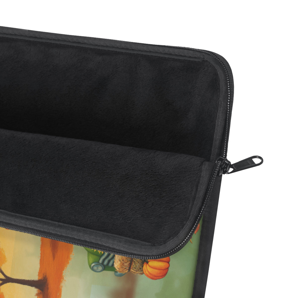 Close-up of a black zippered sleeve or pouch with a soft black interior lining, shown against a white background with a small portion of a colorful printed exterior visible at the bottom.