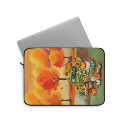 A laptop sleeve featuring a colorful autumn-themed illustration with pumpkins, sunflowers, and orange trees, shown on a white background with a silver laptop partially visible behind it.
