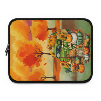 A laptop sleeve featuring a colorful autumn-themed illustration with a green pickup truck loaded with pumpkins, corn, and sunflowers, alongside orange trees and the words 'Happy Fall,' shown on a plain white background.