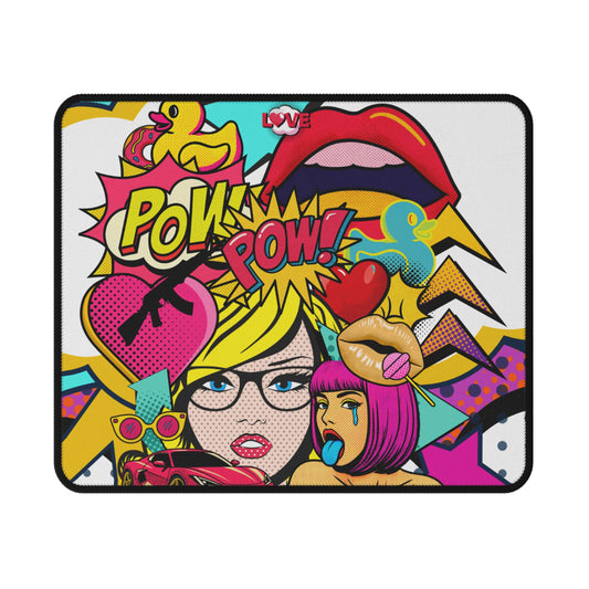 A rectangular mouse pad with rounded corners, featuring a vibrant, multi-colored pop-art comic book illustration. The design includes the words 'POW! POW!' in a yellow comic-style font, a pink heart with a black rifle, a yellow rubber duck, two stylized female faces with pink and yellow hair, and a red lips graphic.