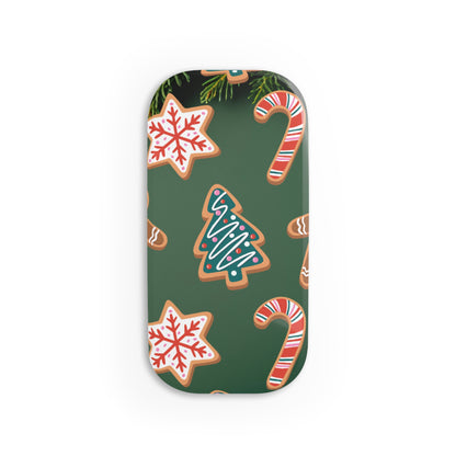 A rectangular phone GRIP with rounded corners featuring a festive Christmas pattern of gingerbread cookies, candy canes, snowflakes, and a Christmas tree on a dark green background.