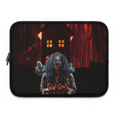 A black laptop sleeve featuring a horror-themed graphic print of a zombie in a dark forest with a haunted house in the background.