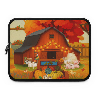 A laptop sleeve featuring a colorful autumn farm illustration with a red barn, pumpkins, sheep, pigs, ducks, and orange-red trees, shown on a plain white background.