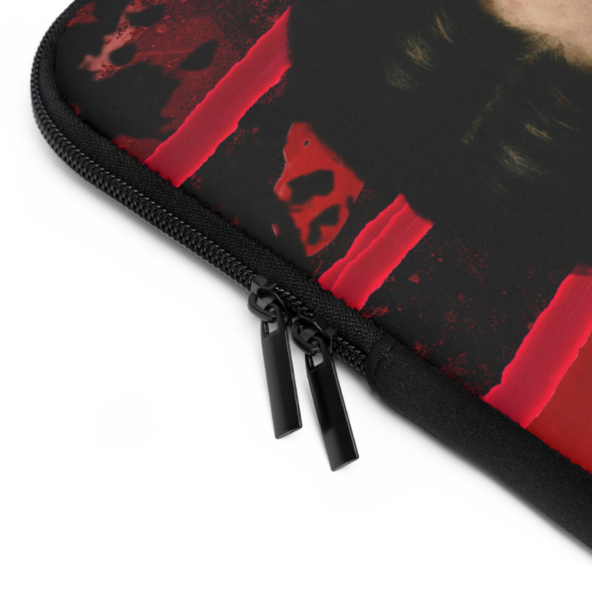 Close-up of a black zippered protective sleeve featuring a graphic print of red paint strokes and a skull on a white background.