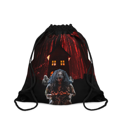 A black drawstring bag featuring a horror-themed graphic print of a zombie holding a bloody knife in front of a haunted house under a red sky.