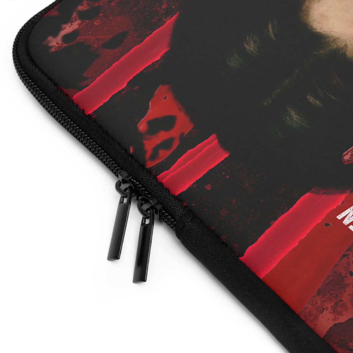 Close-up of a black zippered sleeve or case with a red abstract graphic print and black zipper pulls, shown on a white background.