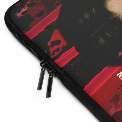 Close-up of a black zippered sleeve or case with a red abstract graphic print and black zipper pulls, shown on a white background.