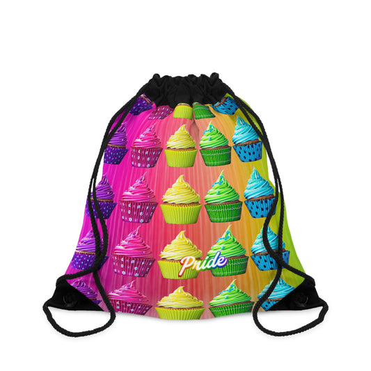 A drawstring backpack with a vibrant, repeating pattern of colorful cupcakes on a rainbow-striped background, featuring the word 'Pride' printed near the bottom center. The drawstrings are black.