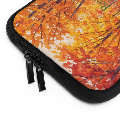 Close-up of a zippered protective sleeve featuring an autumn forest pattern with orange, yellow, and red leaves, black branches, and a black zipper border.