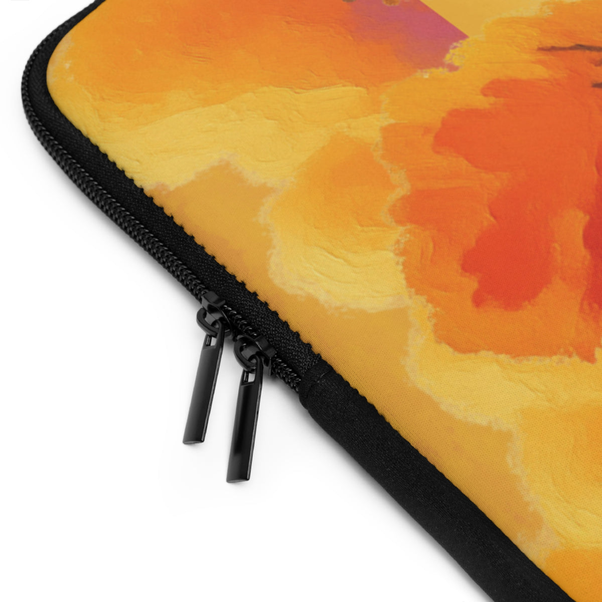 Close-up of a laptop sleeve featuring an abstract watercolor-style design in orange, yellow, and red tones, with a black zipper and dual zipper pulls on a white background.