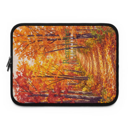 A laptop sleeve featuring a colorful autumn forest print with red, orange, and yellow leaves, black trim, and a zipper on the left side.