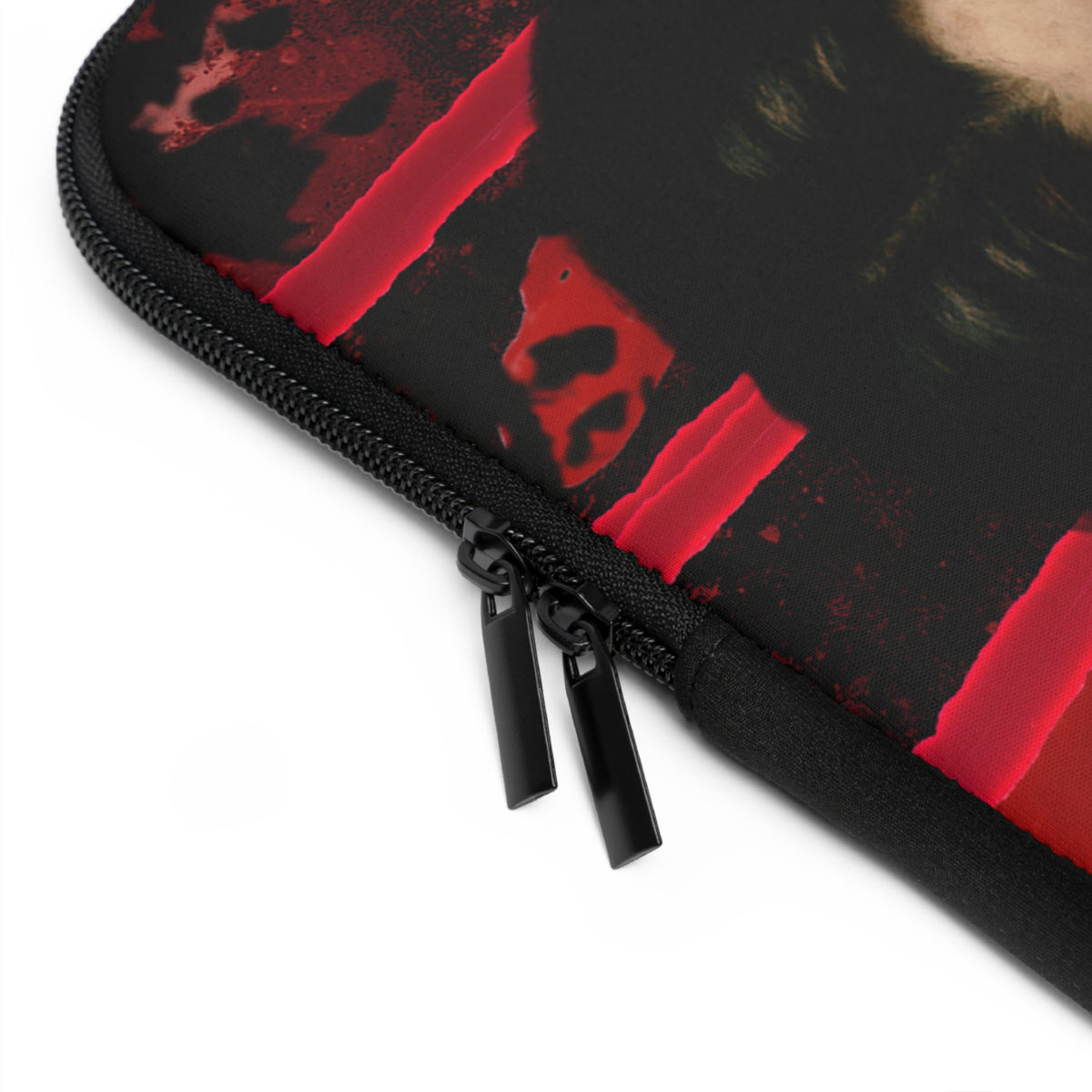 Close-up of a black zippered sleeve or case with a red abstract graphic print and black zipper pulls, shown on a white background.