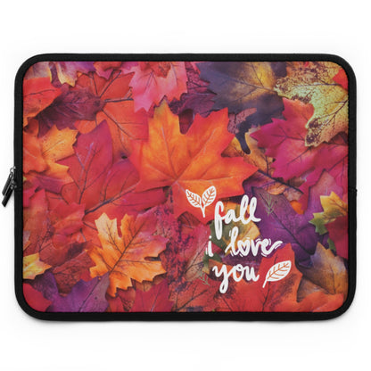 A laptop sleeve featuring a vibrant autumn leaf pattern in shades of orange, red, pink, and yellow, with the white script text 'fall i love you' and small leaf illustrations on the front.