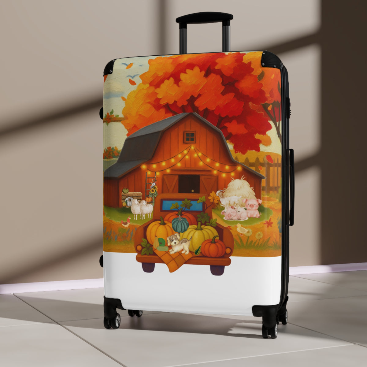 A hard-shell rolling suitcase with a black telescoping handle and wheels, featuring a colorful printed autumn farm illustration on the front. The design shows a barn, string lights, pumpkins, sheep, and a large orange-red tree.
