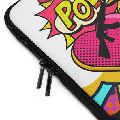 Close-up of a white zippered sleeve with a black zipper and a colorful pop-art comic-style print featuring pink, yellow, black, and turquoise shapes and lettering.