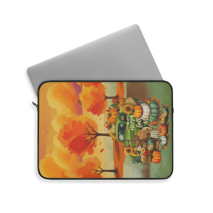 A laptop sleeve featuring a colorful autumn-themed illustration with pumpkins, sunflowers, trees, and a green truck, shown on a white background with a silver laptop partially visible behind it.