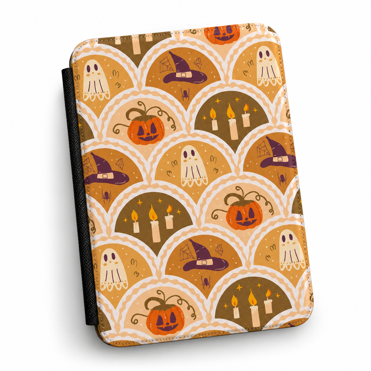 A KINDLE COMPATIBLE CASE featuring a repeating Halloween-themed scallop pattern with jack-o'-lanterns, ghosts, witch hats, and candles in orange, brown, cream, and purple tones, shown on a white background.