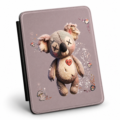A tablet case with a textured dusty purple background featuring a central graphic of a stitched, sad teddy bear with a red 'R.I.